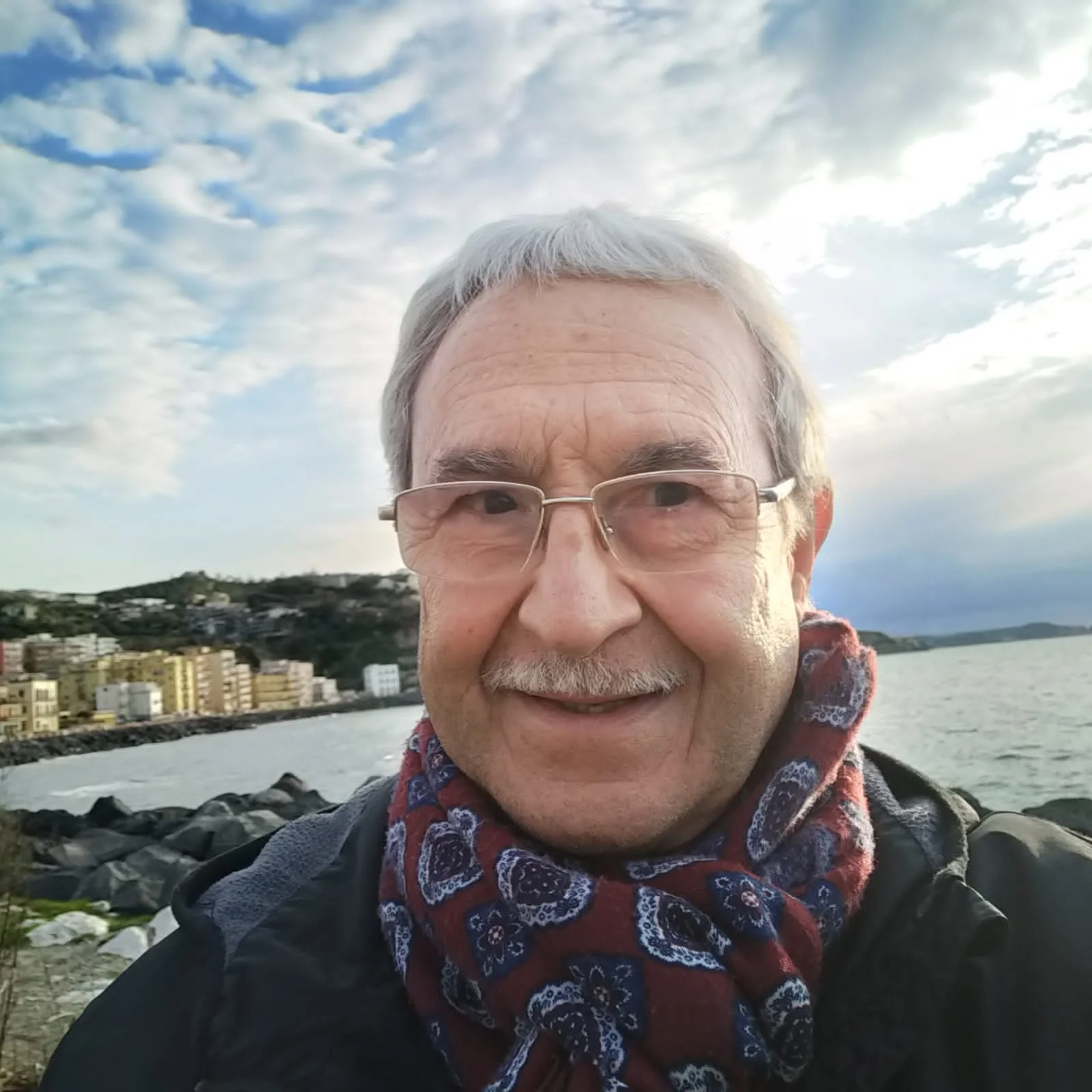 a man with glasses smiling