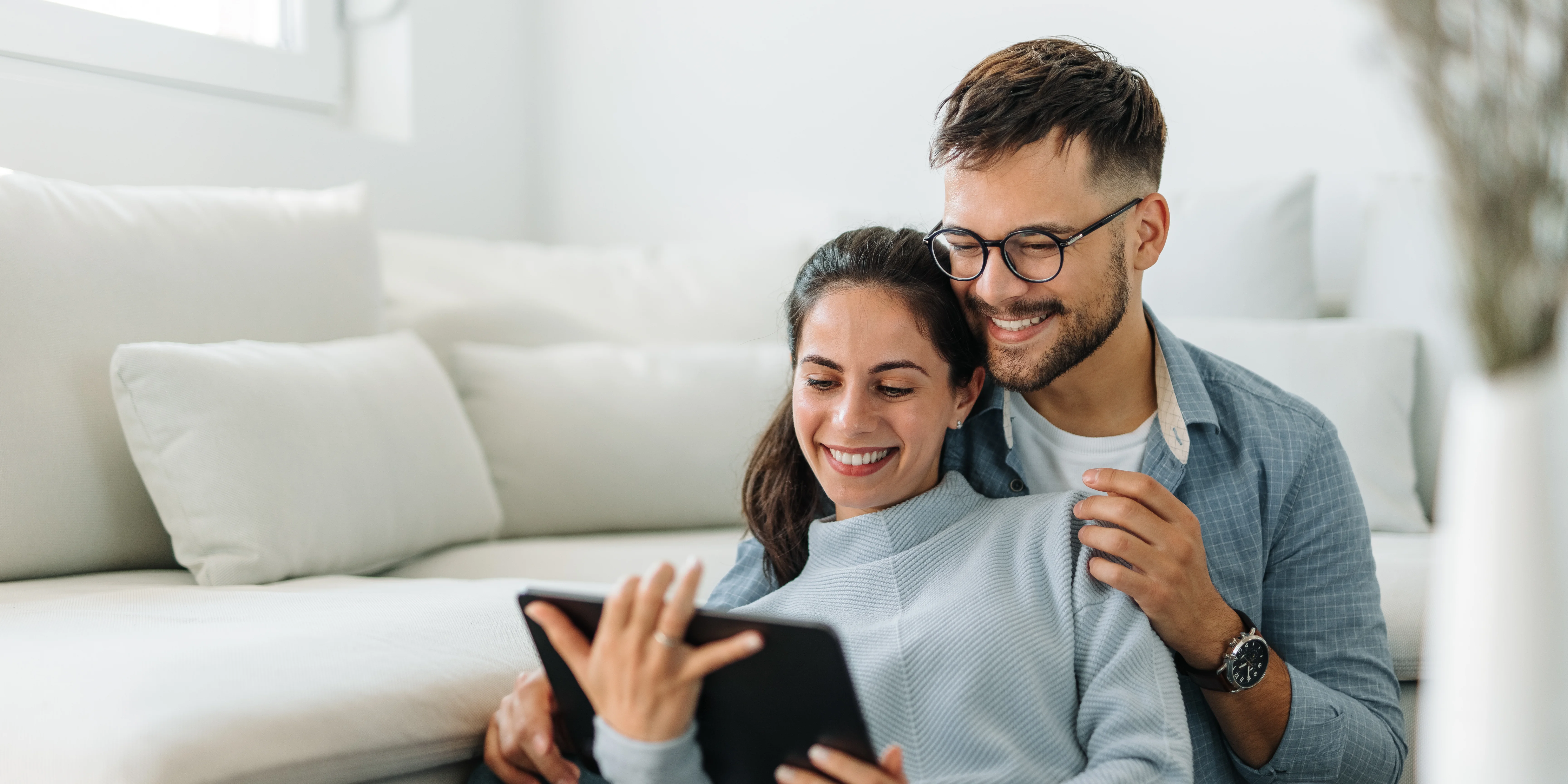 a man and woman looking at a tablet
