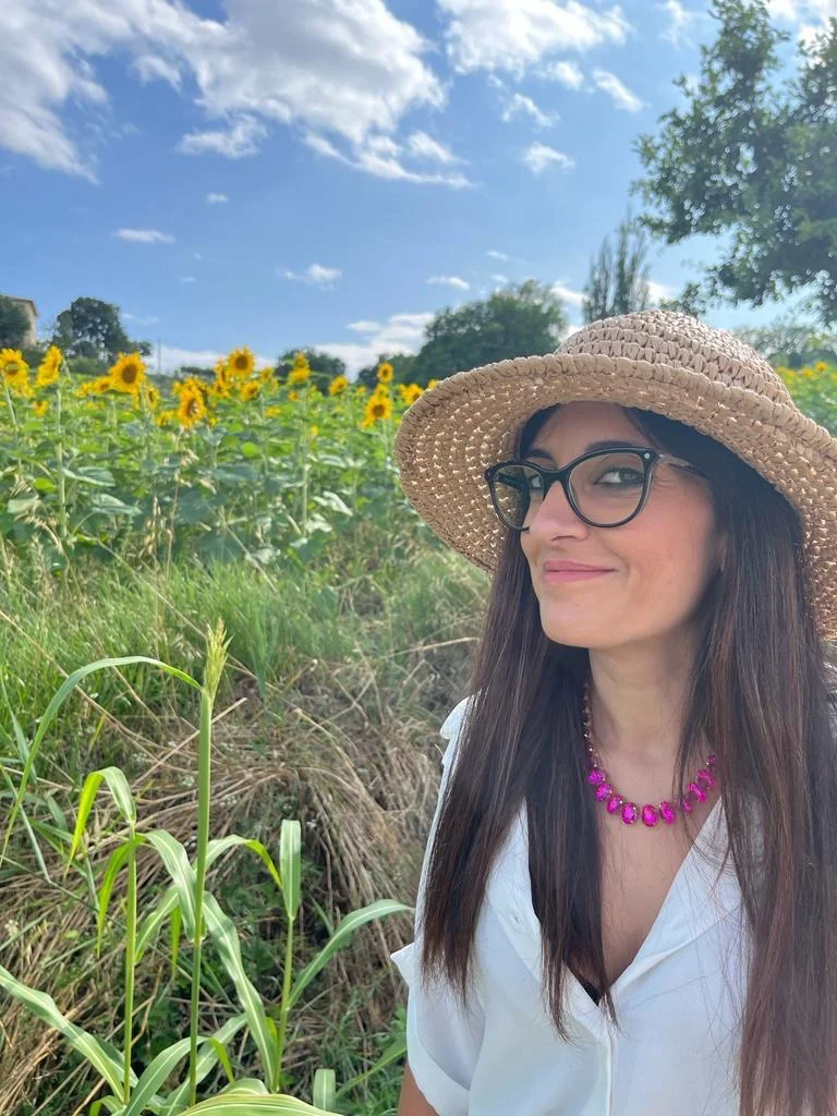 a woman wearing a hat and glasses